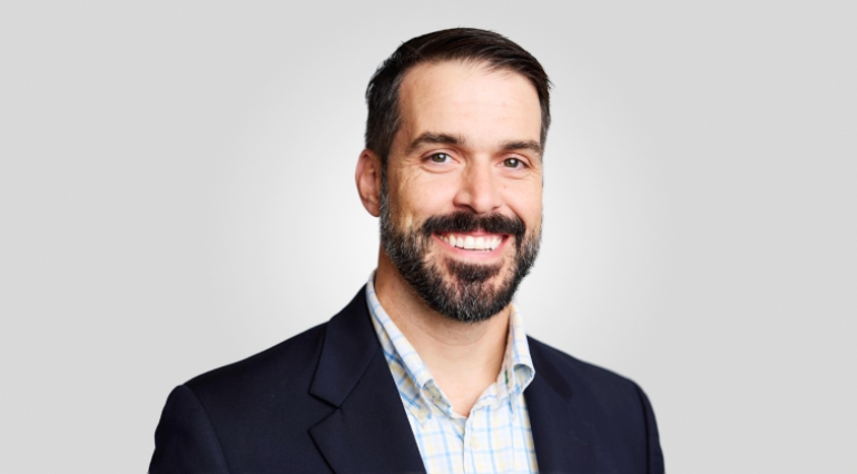 man with bread wearing blue jacket